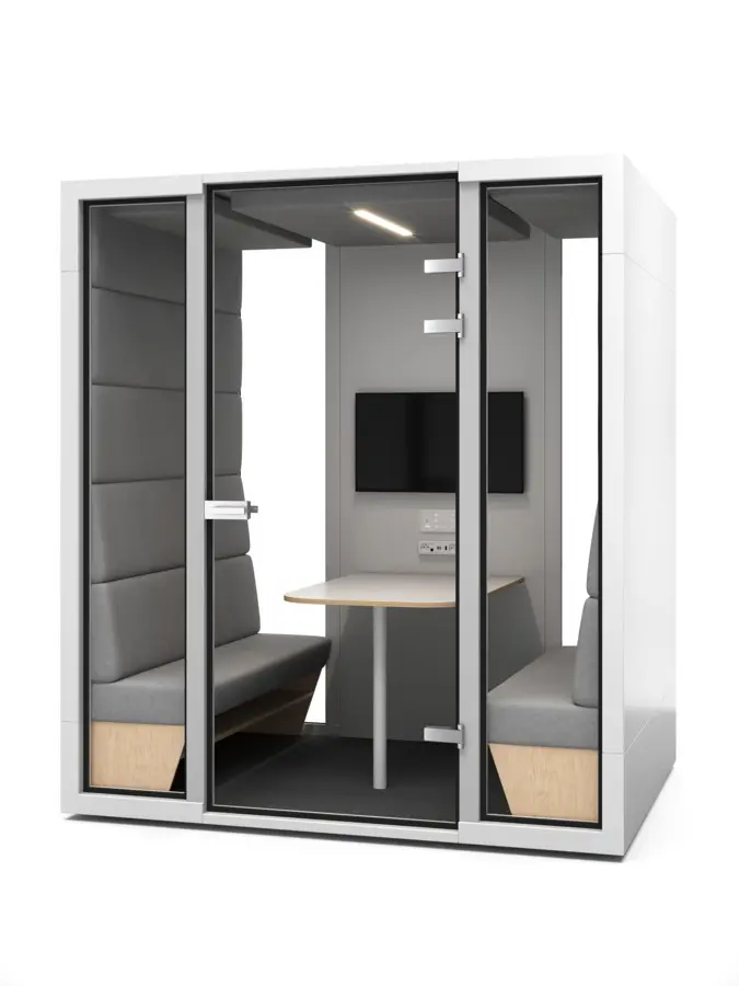 L booth side view — plywood seat bases and table edge in the mini conference room
