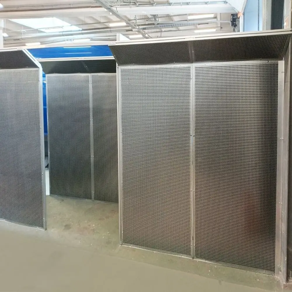 System Q — durable perforated sheet guards filled with acoustic foam for production hall